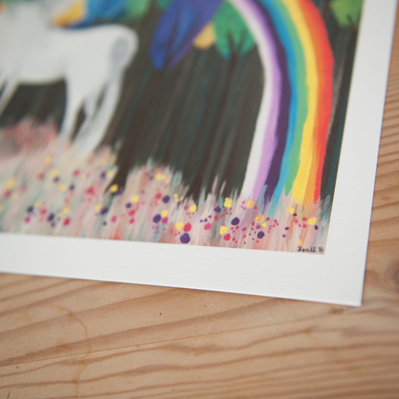 May include: A white unicorn with a rainbow horn stands in a field of flowers. The unicorn is surrounded by a rainbow and green trees. The background is a dark green.