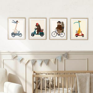 May include: Four framed wall art prints featuring whimsical animal illustrations. The first shows a giraffe on a motorcycle with a sidecar, the second a bear on a scooter, the third a bear on a bicycle with books, and the fourth a giraffe on a red scooter.