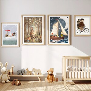 May include: Four framed wall art prints featuring whimsical animal illustrations, including a boat with animals, a rabbit reading in a forest, a sailboat under a crescent moon, and a bear riding a bicycle, displayed above a wooden crib and toys.