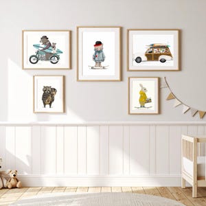 May include: A gallery wall set of five framed art prints featuring whimsical animal illustrations. The prints depict a bear on a motorcycle, a bear on a skateboard, a woody station wagon with surfboards, a raccoon with a skateboard, and a rabbit.