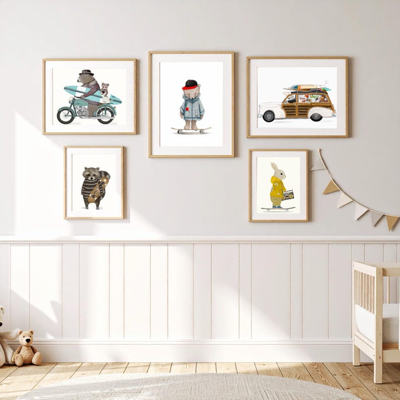 May include: A gallery wall set of five framed art prints featuring whimsical animal illustrations. The prints depict a bear on a motorcycle, a bear on a skateboard, a woody station wagon with surfboards, a raccoon with a skateboard, and a rabbit.