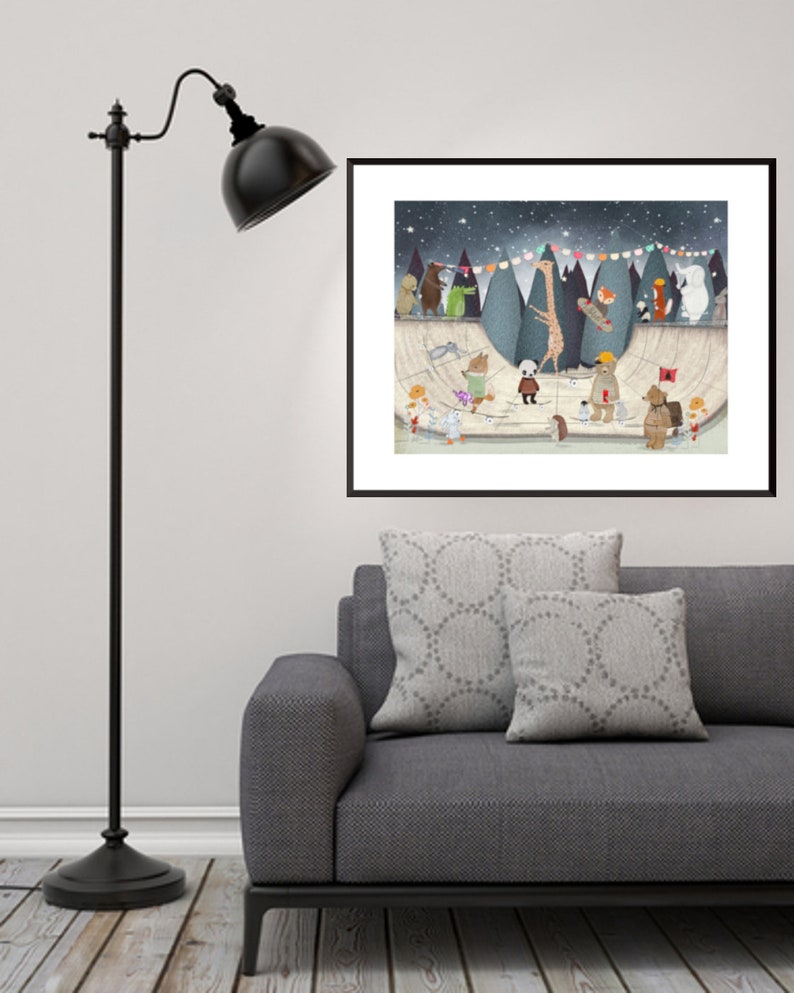 May include: A framed wall art print featuring a whimsical illustration of various animals, including a giraffe, bear, and panda, gathered at a skate park under a starry night sky with colorful bunting flags strung across the dark blue background.