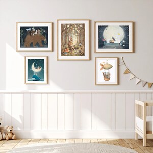 May include: A gallery wall set of five framed art prints featuring whimsical animal illustrations. The prints depict a large brown bear, a rabbit in a forest, an elephant in a boat under a full moon, a whale with a crescent moon, and a hot air balloon.