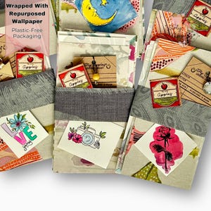 May include: A white ceramic mug with a black handle and the text "But First, Coffee" in a bold, black font. The mug is set against a blurred background, suggesting a cosy setting.