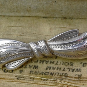 Antique sterling silver engraved bow brooch