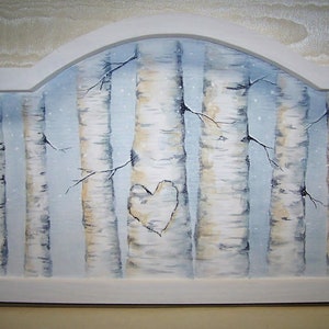 May include: A white wooden frame with a painting of a birch tree forest. The trees are painted in shades of white, gray, and brown. A heart shape is carved into one of the trees.