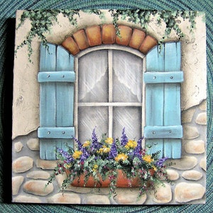 May include: A square painting depicts a window with light blue shutters, a brick arch, and a stone wall. A window box filled with purple and yellow flowers sits below the window. Green vines cascade from the top.
