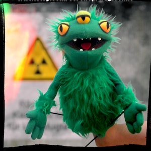 three eyes hand puppet monster