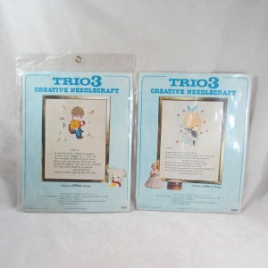 May include: Two vintage needlepoint kits featuring a boy and a girl. The kits are packaged in plastic and include embroidery floss, needles, and instructions. The kits are titled "Trio 3 Creative Needlecraft" and feature a poem about the subjects of the kits.