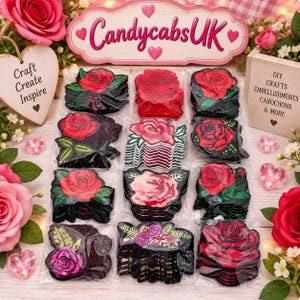 May include: A collection of rose-shaped patches arranged in twelve clear plastic packets. The patches feature various red, pink, and purple rose designs with green leaves, some with black backgrounds. A sign reads CandycabsUK, Craft Create Inspire.