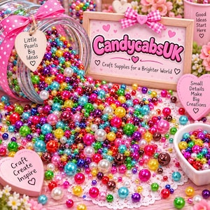 May include: A glass jar tipped on its side spilling a large collection of multicolored, glossy, round craft pearls in various sizes. A wooden sign displays the text CandycabsUK Craft Supplies for a Brighter World, surrounded by heart-shaped tags with text.