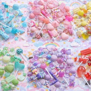 May include: A colorful assortment of candies, including lollipops, gummy bears, and hard candies, in shades of blue, pink, yellow, green, purple, and red. The candies are arranged on a pastel background with rainbows and clouds.