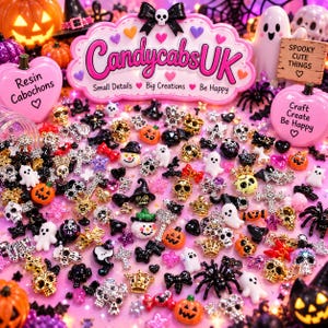 May include: A collection of small resin cabochons featuring Halloween-themed shapes including skulls, ghosts, pumpkins, spiders, crowns, and bows in various colors. The display includes signs with the text CandycabsUK, Resin Cabochons, and Spooky Cute Things.