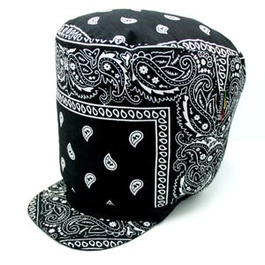 May include: Black and white bandana-patterned cap with a flat brim. The cap features a repeating paisley design in white against a black background. The brim and the cap's crown are covered in the same pattern. The cap has a structured, military-style shape.