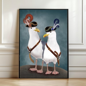 May include: A framed art print featuring two white seagulls adorned with miniature pirate hats and brown leather harnesses. The seagulls stand on a small mound against a teal background. One hat has red feathers, the other blue.