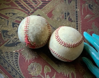 Vintage pair well used baseballs old age worn shabby leather game balls sports decor display props