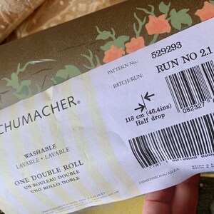 May include: A white label with black text and a barcode. The label reads "SCHUMACHER. PATTERN No.: 529293 BATCH/RUN: RUN NO 2.1 WASHABLE LAVABLE LAVABLE ONE DOUBLE ROLL UN ROULEAU DOUBLE UNO ROLLO DOBLE 118 cm (46.4ins) Half drop 082327 692687 DIMENSIONS/AREA".