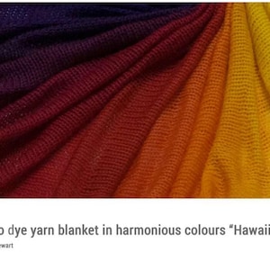 May include: A close-up of a yarn blanket dyed in a gradient of colours, transitioning from deep purple to red, orange, and finally yellow. The text "How to dye yarn blanket in harmonious colours "Hawaii Sunset"" is at the bottom.