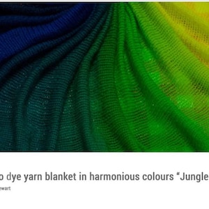 May include: A close-up of a yarn blanket dyed in shades of blue, green, and yellow. The fabric is draped, showing the texture and colour gradients. The title "Jungle Lake" is included.