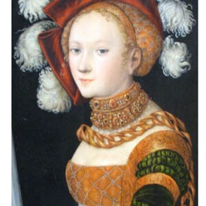 May include: A portrait painting of a woman wearing a red and white feathered hat, a gold necklace, and a yellow and green dress. The painting is titled "Judith with the head of Holofernes" by Lucas Cranach the Elder, 1530.
