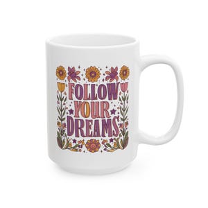 the 15 oz version of a floral boho ceramic mug with the text 'Follow Your Dreams'