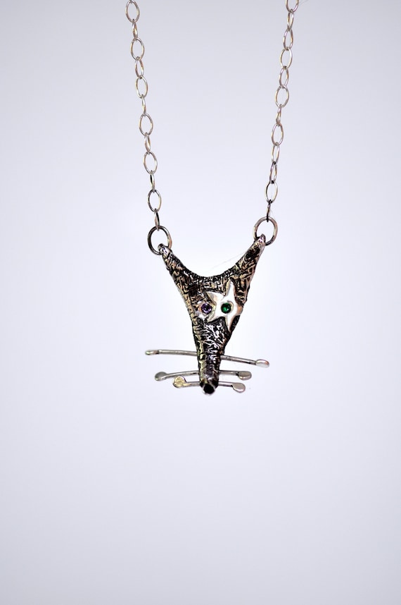 A handmade silver rat necklace that leans fully into the 'rat royalty' aesthetic — genuinely weird, genuinely cool oddity jewelry.
