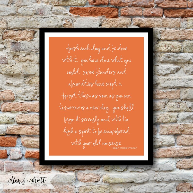 May include: A framed print with a black border features a vibrant orange background with white cursive text. The text is a quote by Ralph Waldo Emerson. The bottom left corner displays the text "Alexis Scott Designs".
