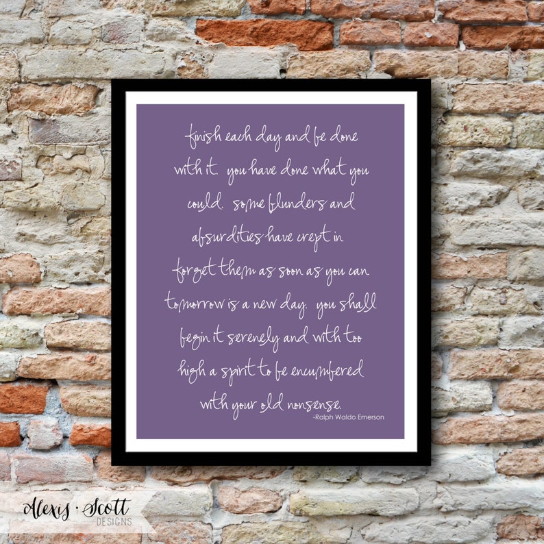 May include: A framed print with a black border. The print features a purple background with white cursive text quoting Ralph Waldo Emerson. The text reads, "finish each day and be done with it..." The bottom left corner has the text "Alexis Scott DESIGNS."