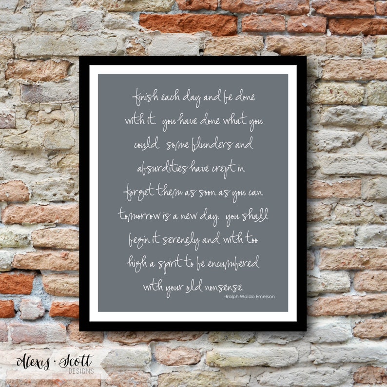 May include: A framed print with a gray background and white script. The text is a quote by Ralph Waldo Emerson, set against a black frame. The bottom left corner has the text "Alexis Scott Designs".