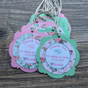 May include: Pink and green thank you tags with a teacup and teapot design. The text reads "Thank You for making my TEA-rific Kenadie".