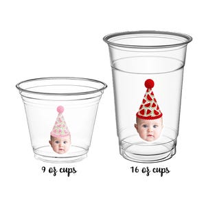 May include: Two clear plastic cups labeled 9 oz cups and 16 oz cups. Each cup features a graphic of a baby wearing a party hat with a watermelon pattern. The text KT BLUE CREATIONS appears at the top with a small unicorn and cloud icons.