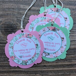 May include: Pink and green thank you tags with a teacup and teapot design. The text reads "Thank You for making my party TEA-rifiel Kenadie".