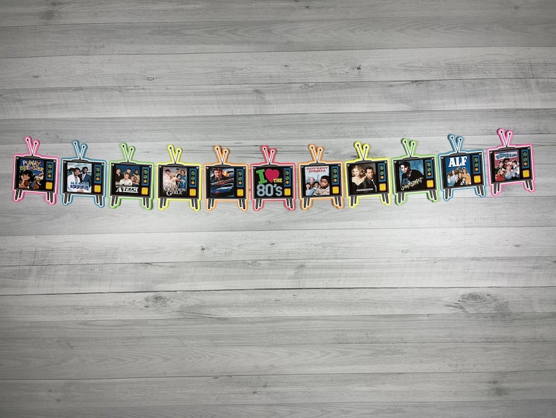 May include: A string of 12 colorful television-shaped decorations with images of popular 1980s television shows, including "The Facts of Life", "ALF", "I Love the 80s", and "Punky Brewster".