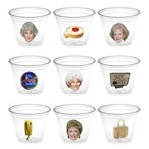 May include: Nine clear plastic cups with various designs from the television show Golden Girls. The designs include a cheesecake, a character's face, and a sign for the Rusty Anchor.