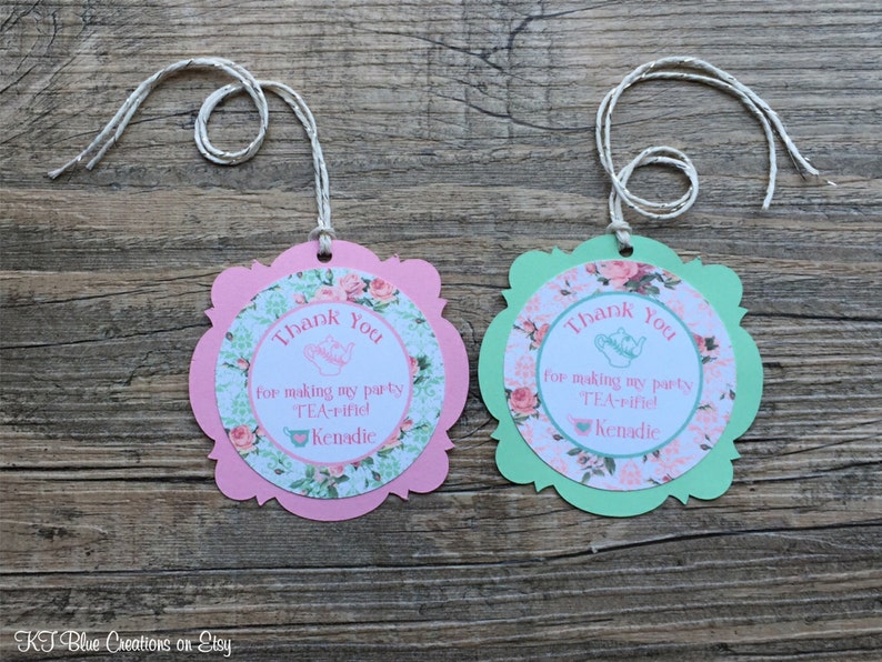 May include: Two pink and green thank you tags with a teacup and teapot design. The text on the tags reads "Thank You for making my party TEA-rified! Kenadic".