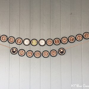 May include: A brown and black banner with the words "Happy Birthday Mason" in white letters. The banner is strung on a wall with a brown wooden background.