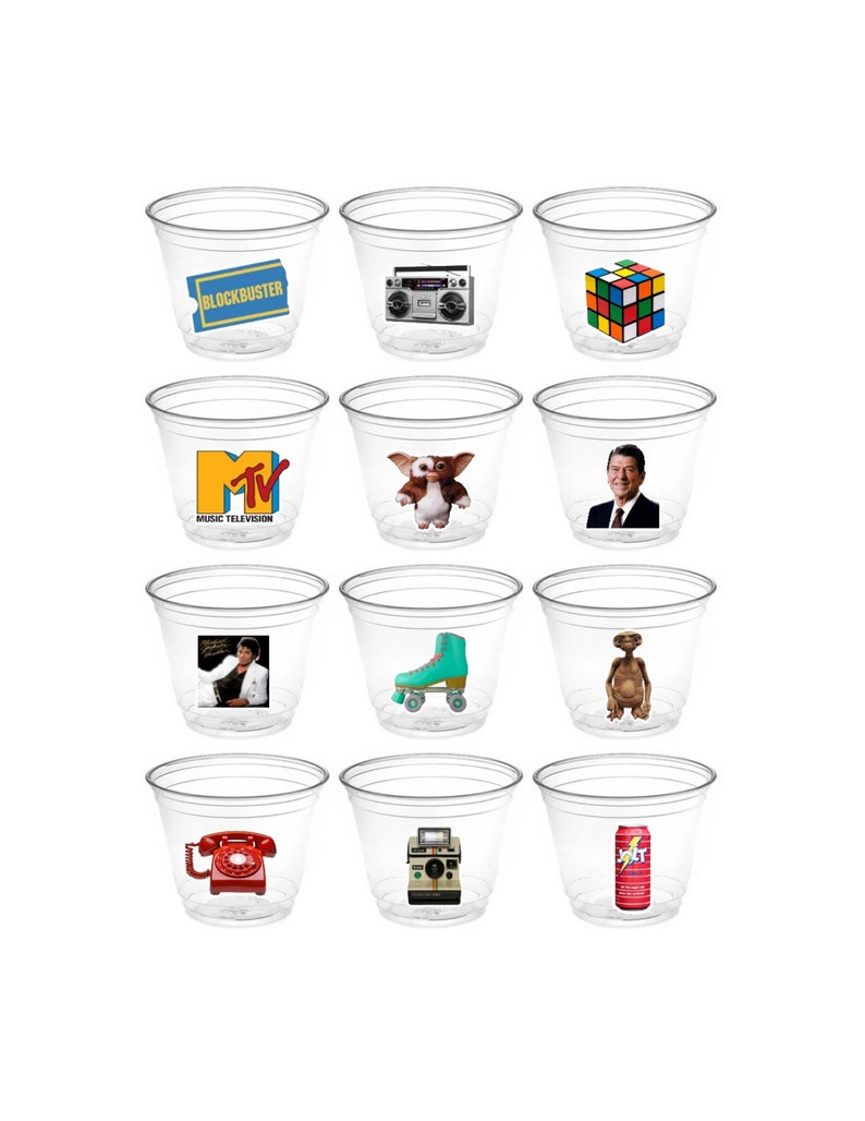 May include: Twelve clear plastic cups with various 1980s themed images printed on them. The images include a Blockbuster Video ticket, a boombox, a Rubik's Cube, the MTV logo, a character from the movie E.T., a photo of Ronald Reagan, roller skates, a red rotary phone, an instant camera, and a can of Jolt Cola.