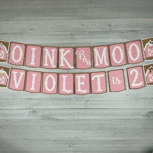 May include: Pink and brown banner with the text "OINK Moo Violet is 2" with farm animal illustrations.