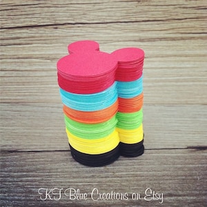 May include: A stack of colorful Mickey Mouse head-shaped paper cutouts in red, blue, orange, green, yellow, and black.