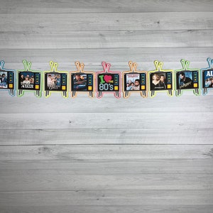 May include: A colorful garland of 10 retro television screens with images of popular 1980s movies and TV shows, including "Punky Brewster", "ALF", and "The Breakfast Club". The garland is perfect for a 1980s themed party or event.