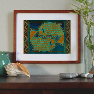 May include: A framed print of a stylized geometric design of two fish in a circle. The fish are gold with a teal and blue background. The frame is brown wood.