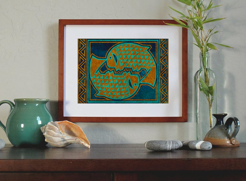 May include: A framed print of a stylized geometric design of two fish in a circle. The fish are gold with a teal and blue background. The frame is brown wood.