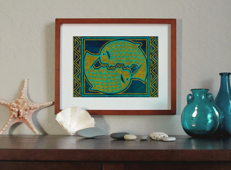 May include: A framed print of two stylized fish in gold and teal colors on a blue background. The fish are surrounded by a geometric border.