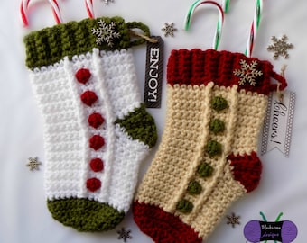 May include: Two crocheted Christmas stockings with candy canes, snowflakes, and tags that say "Enjoy!" and "Cheers!"