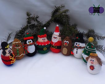 May include: A collection of handmade crochet Christmas ornaments in various festive designs. The ornaments include a nutcracker, gingerbread man, penguin, Santa Claus, reindeer, snowman, Christmas tree, and angel. Each ornament is uniquely detailed with vibrant colors.