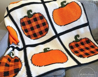 May include: A crocheted throw blanket with a white background and black squares. Each square features a crocheted pumpkin in orange, black, and green. The blanket is on a gray couch. The text "Blackstone Designs" is in the lower right corner of the image.