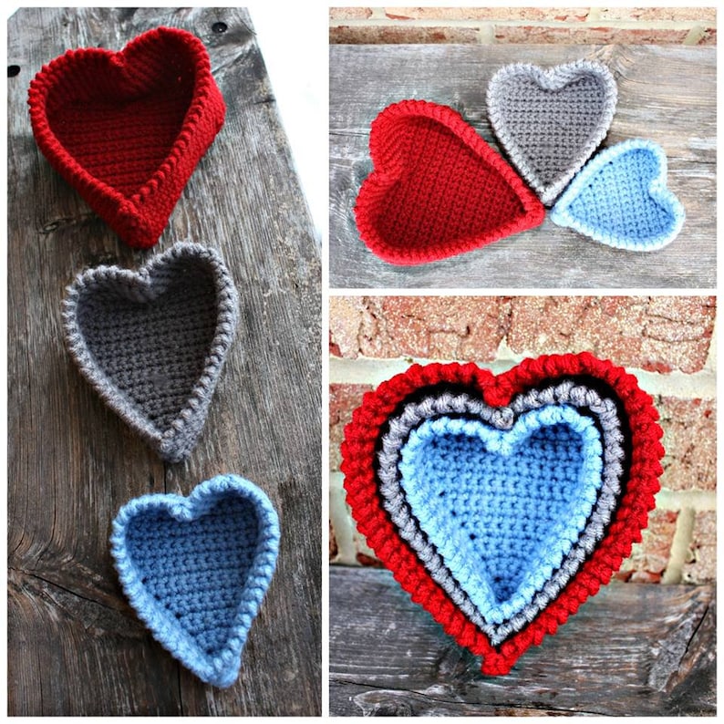 May include: Three crocheted heart-shaped baskets, one red, one gray, and one blue. The baskets are nested inside each other, with the largest basket on the bottom and the smallest basket on top.