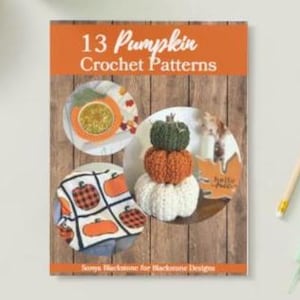 May include: A book cover titled 13 Pumpkin Crochet Patterns by Sonya Blackstone for Blackstone Designs. The cover features a wood-grain background with three circular images showing various crocheted pumpkin designs and a plaid pumpkin blanket.