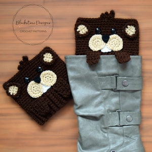 May include: Two brown crocheted beaver boot toppers. The larger topper is partially inside a gray boot with buckles. The smaller topper is lying on a wood surface. The text "Blackstone Designs CROCHET PATTERNS" is visible in the top left corner of the image.