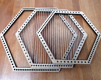 May include: Three wooden hexagonal loom frames, nested together. The largest frame is empty, the middle frame is strung with white yarn, and the smallest frame is empty.